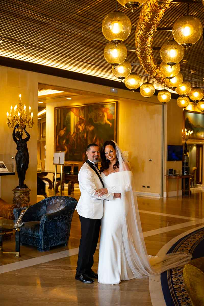 Bride & groom reunited gown and suit taking portrait pictures together luxurious Italian hotel