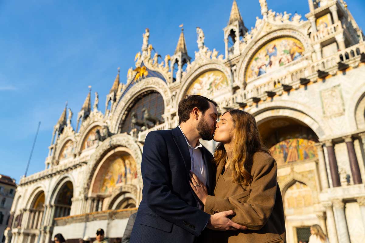 Couple kissing in front of Palazzo Ducale center of Venice Saint Mark's place