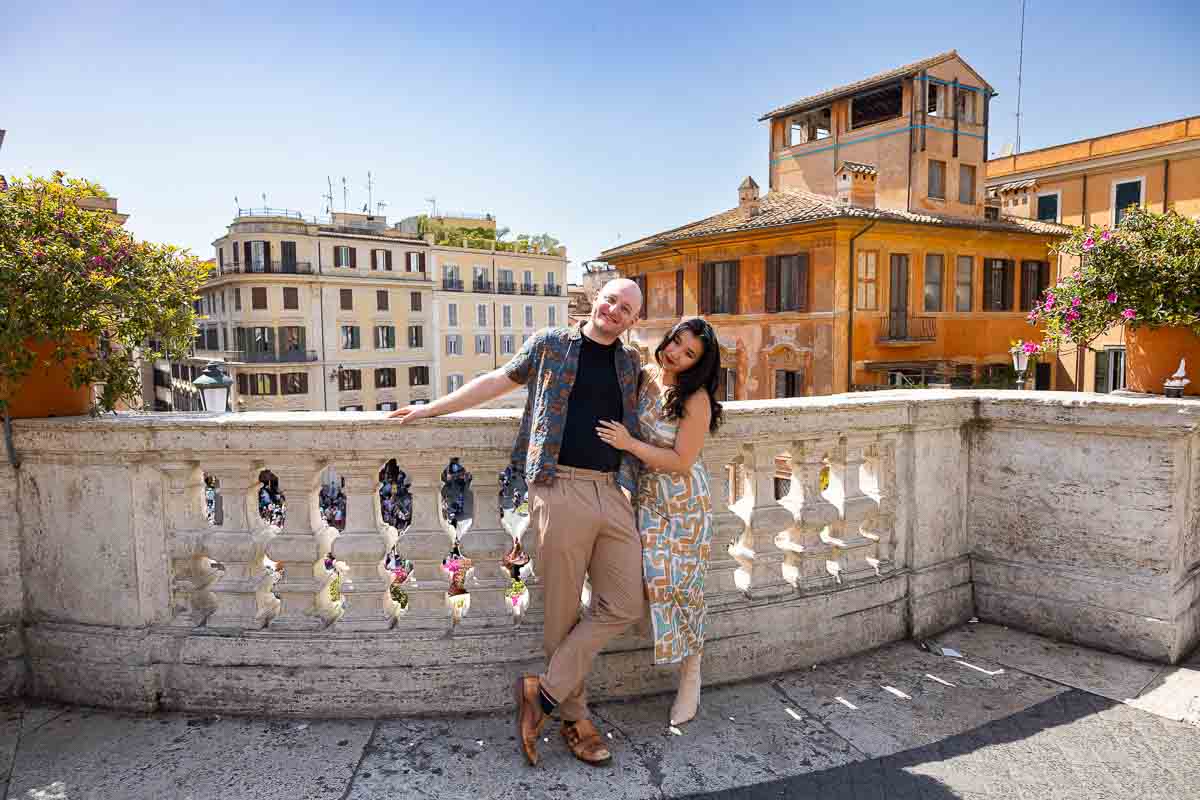Just engaged couple posing by the balconade facing via condotti