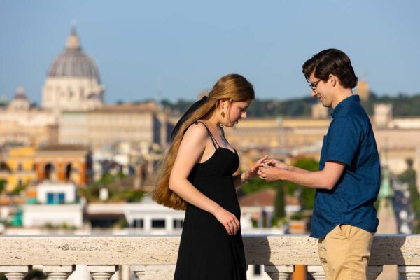006-placing-engagement-ring Putting the engagement ring on the finger after a surprise marriage proposal in Rome Italy