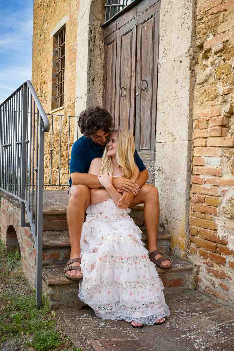 Intimate sitting down shots of a couple together Tuscan countryside 