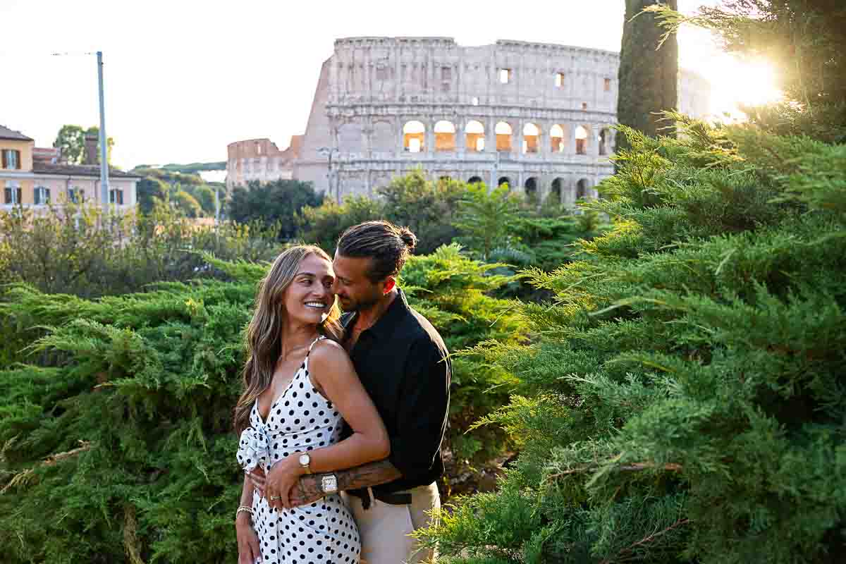 Couple posing Colosseum at sunset