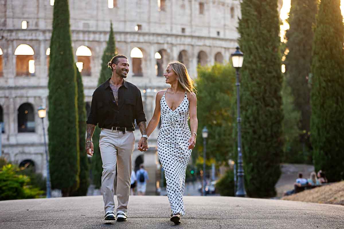 Walking hand in hand in park with a unique view Colosseum