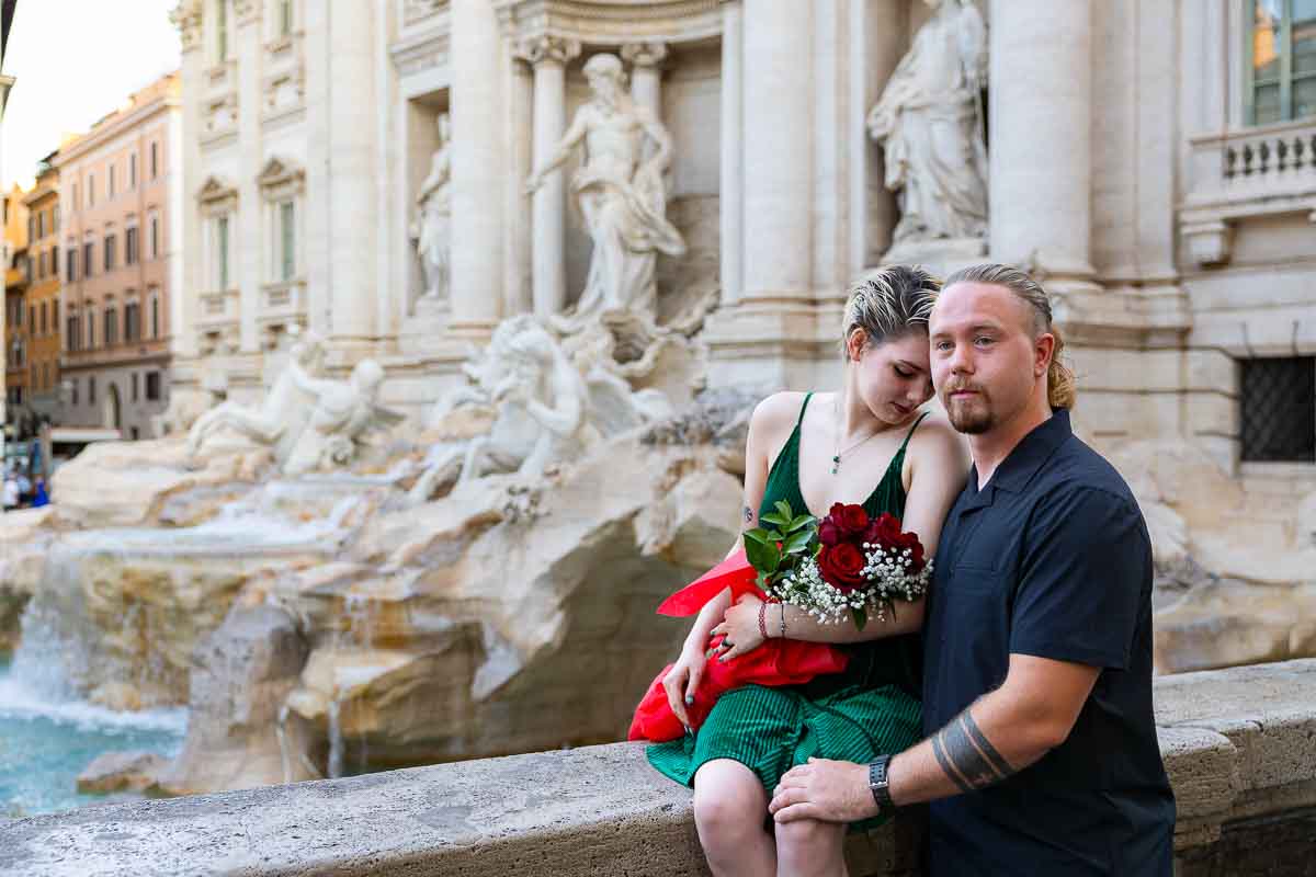 Just engaged posing top Trevi water fountain after a beautiful and romantic Surprise Wedding Engagement