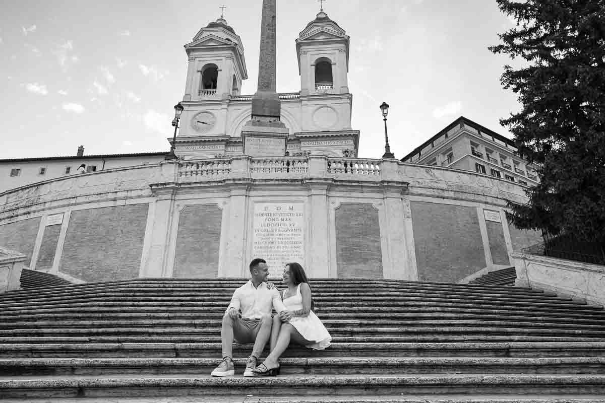 Couple sitting down spanish steps without anyone around
