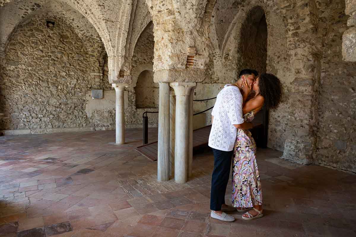 Taking engagement pictures underneath the ancient columns