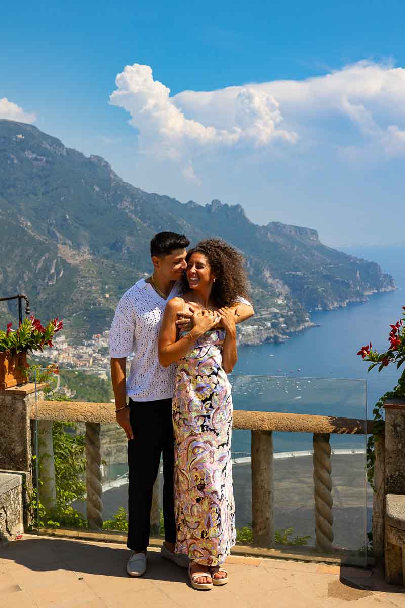 Standing together just engaged during a couple photo shoot after proposing over panoramic view Italian seascape riviera