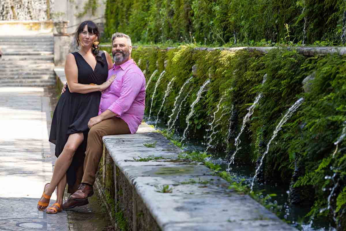 Couple engagement photos by water fountains gushing water 
