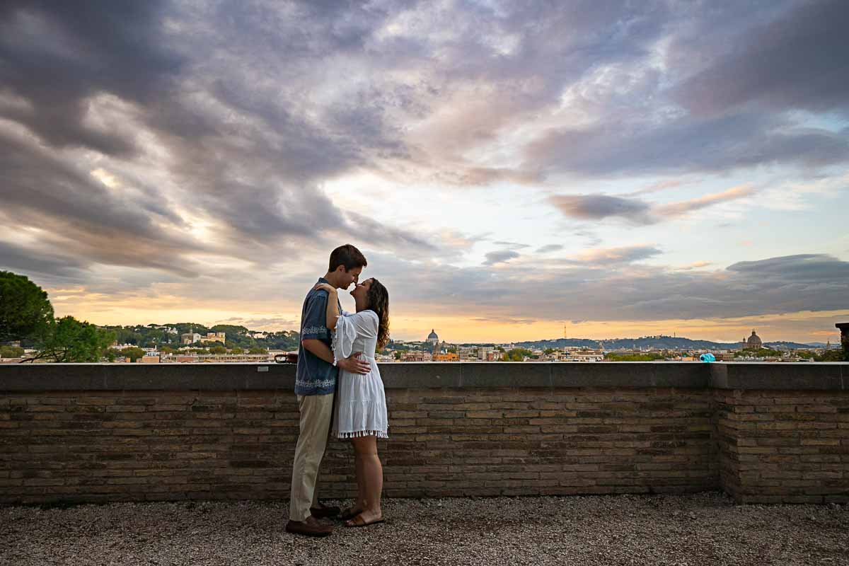 Romantic picture of a couple standing close together taking pictures before the sweeping view from the terrace