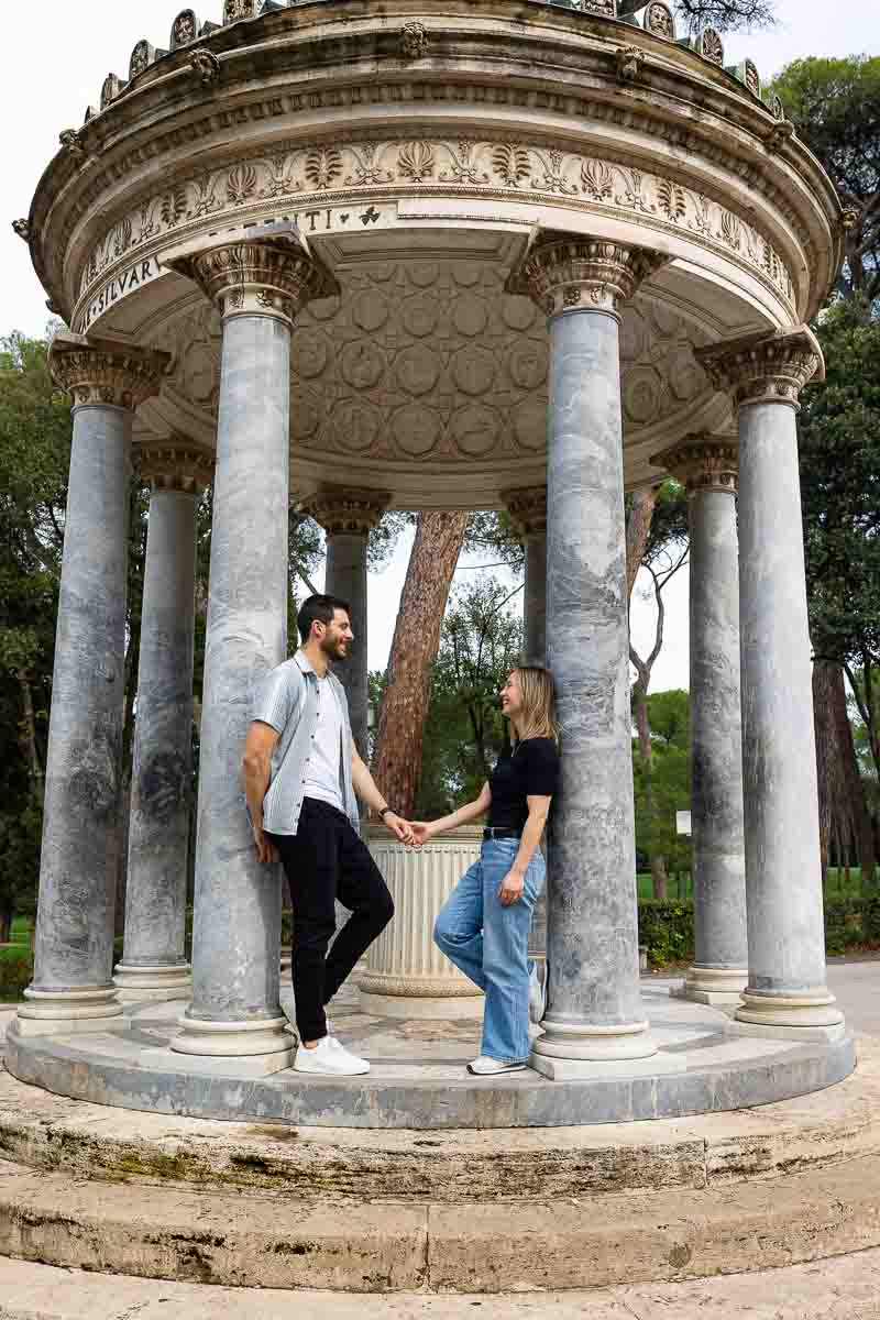 Standing Diana Temple steps taking engagement photos in Italy