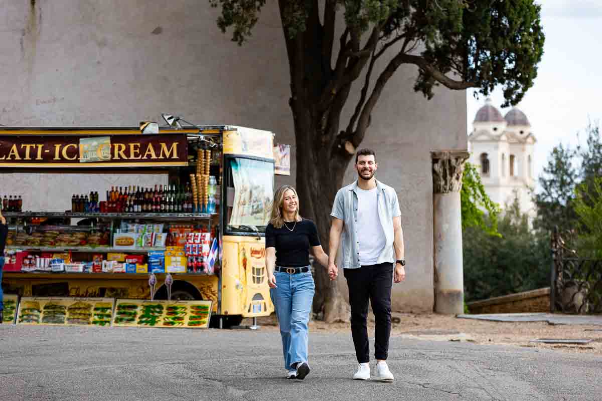 Walking together holding hands in front of a typical beverage truck