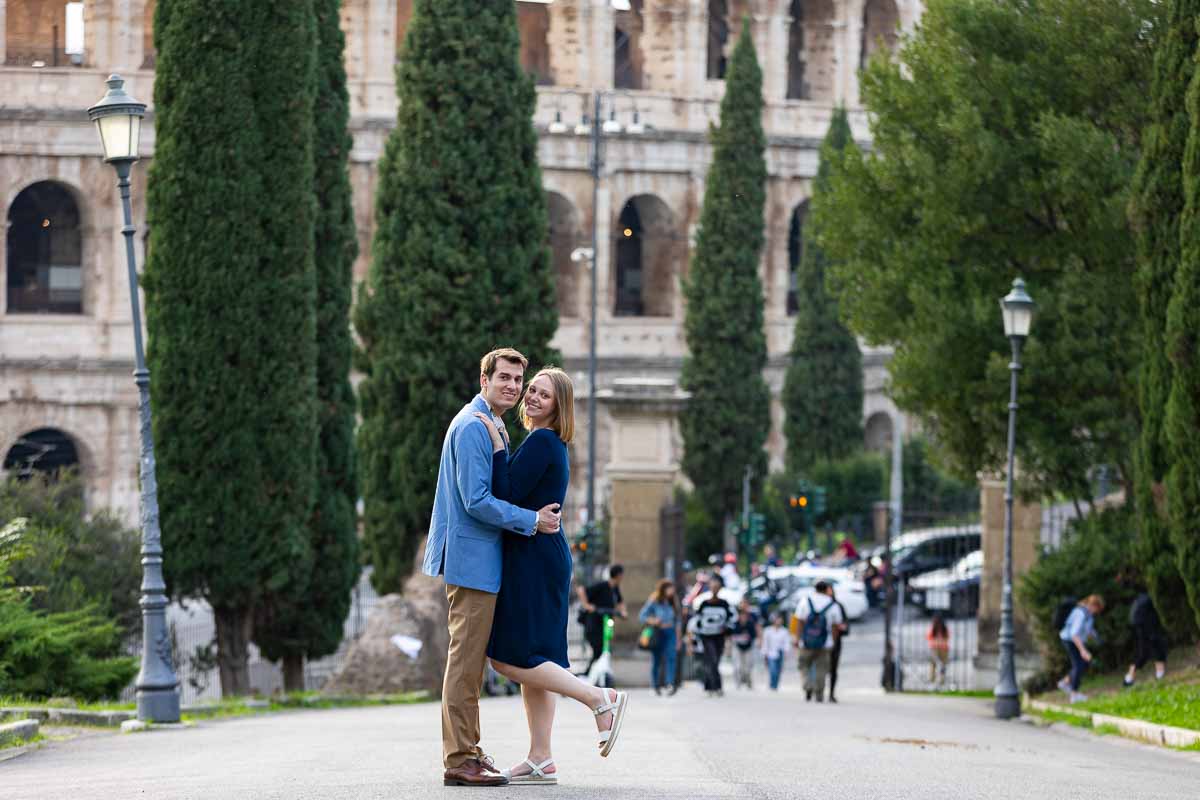 Taking just engaged pictures at the Roman Colosseum during a photography session with a professional photographer in Rome Italy