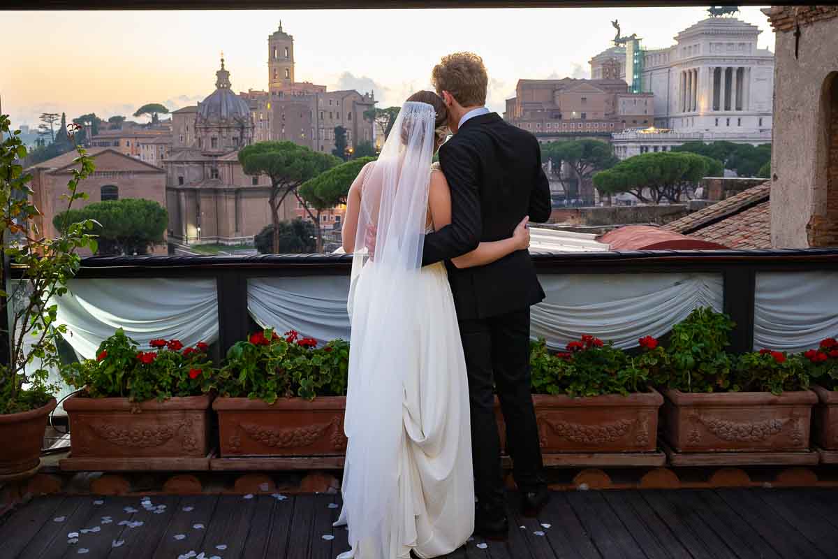 Couple admiring the sunsetting view over the roman skyline