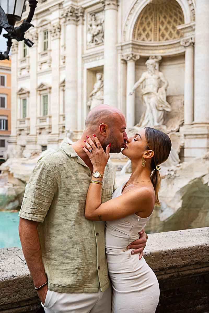 Couple kissing by the Trevi fountain during an Engagement Photoshoot in Roma Italy
