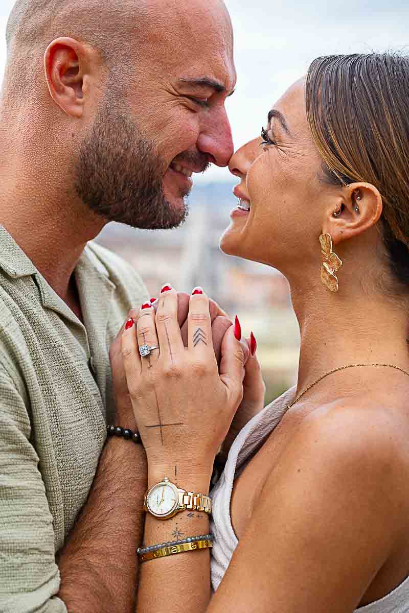 Close up of a couple holding hands displaying the engagement ring in the Photo Session