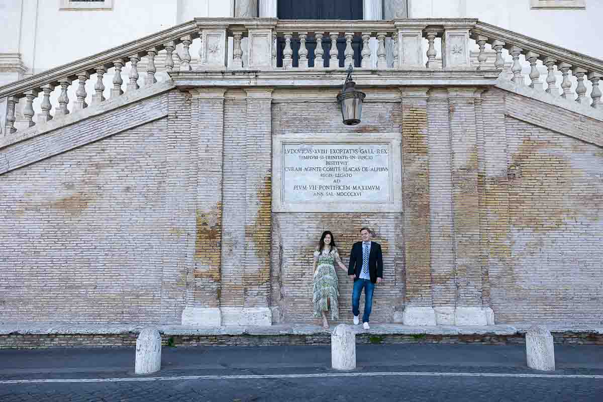 Standing underneath a marble staircase found at the bottom of Trinita' dei Monti on top of the Spanish steps