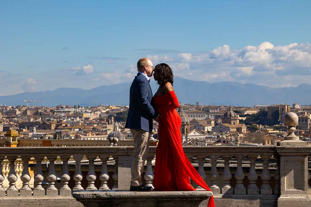 Standing together on a marble bench overlooking the cityscape above Janiculum hill photographed by a photographer using a telephoto lens