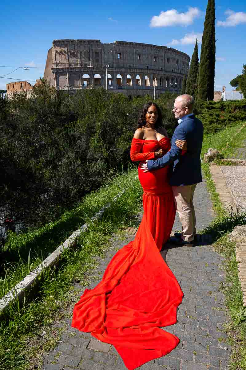 Colosseum pictures taken during a maternity shoot in Italy using a bright red dress