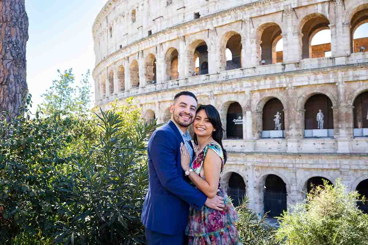 Posed portrait of a couple standing at the Colosseum. Photos and Videography in Italy while on an engagement photography session