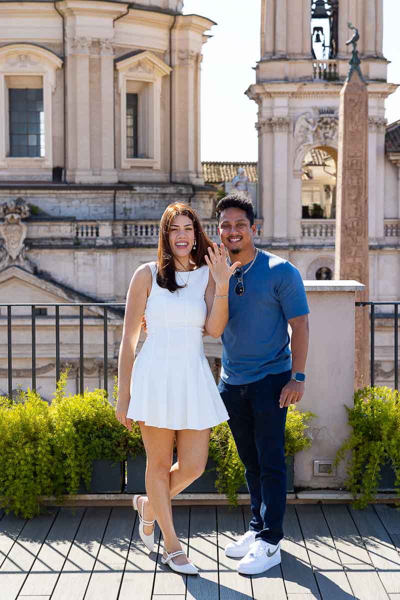 Just engaged on a rooftop terrace overlooking the roman skyline and showing off the engagement ring 