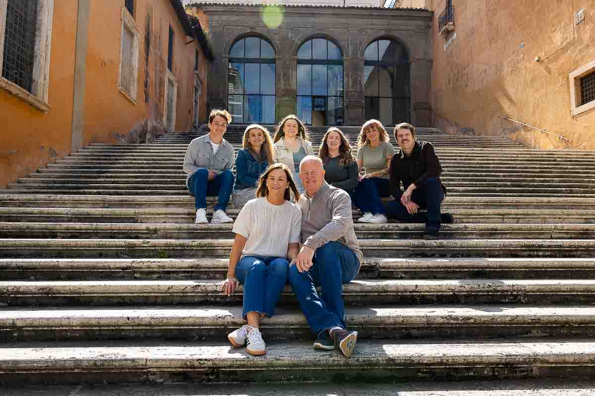 Close-up portrait capture of a family's loving moment on a staircase during a photo shoot in Rome
