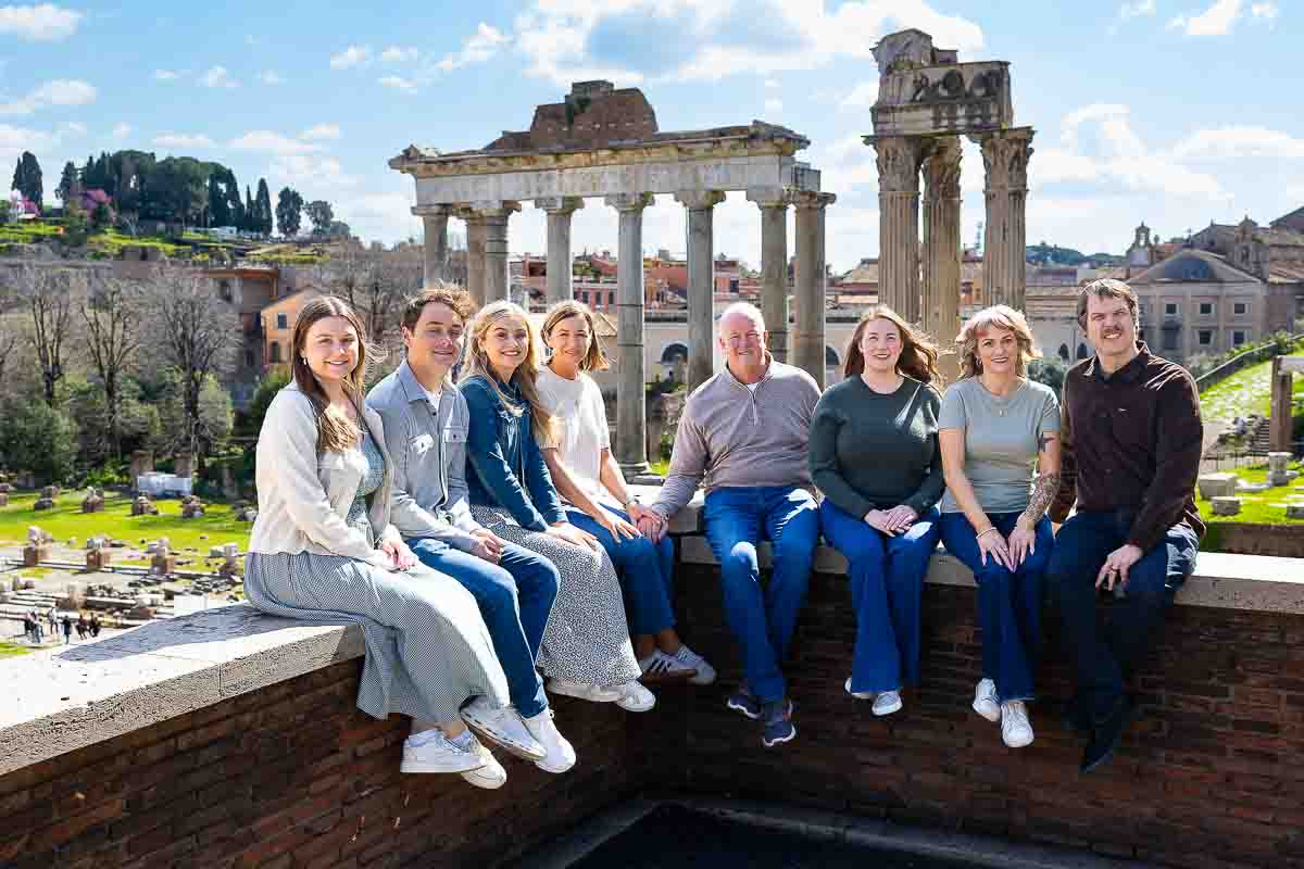 Intimate moment at the Roman Forum: A close-up group portrait admiring the ancient temple, taken during a professional photography session