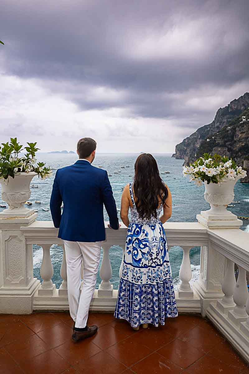 Couple admiring the mediterranean sea from a hotel balcony during a photography session on the Amalfi coast