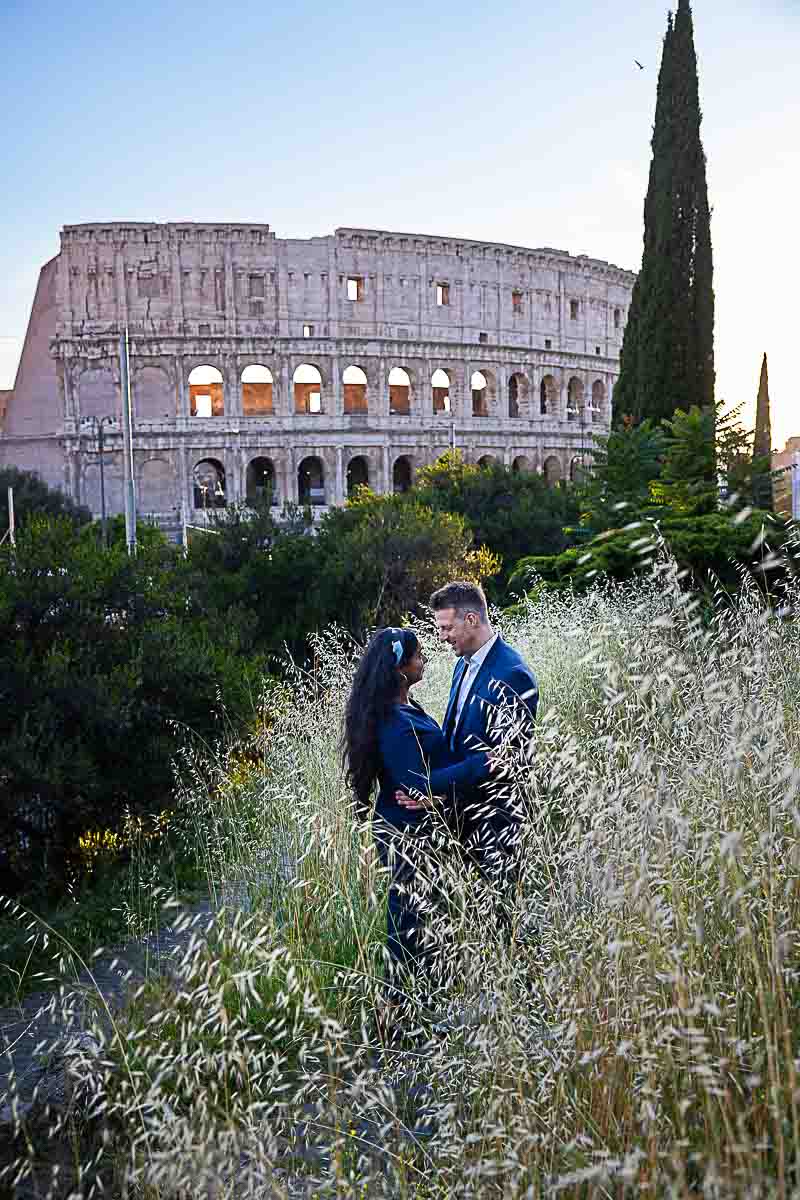 Posed among high grass with the major landmark in the background. Maternity Colosseum Proposal PhotoShoot