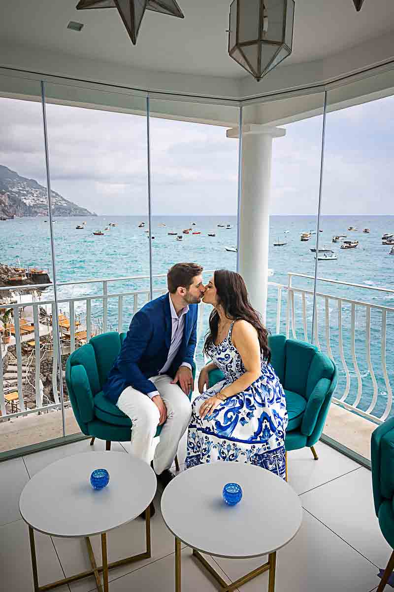 Kissing indoor with the sea outside during photo picture taking on mediterranean sea