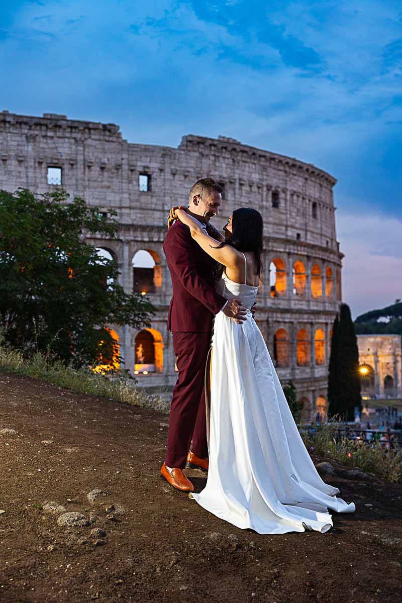 Couple taking pictures at night during a wedding photoshoot Colosseum Italy