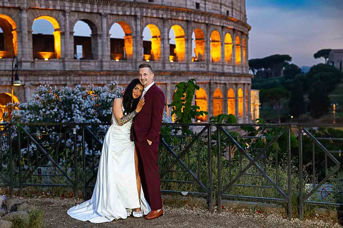 Posed snapshot of a couple just married in Italy and taking wedding photos at Coliseum