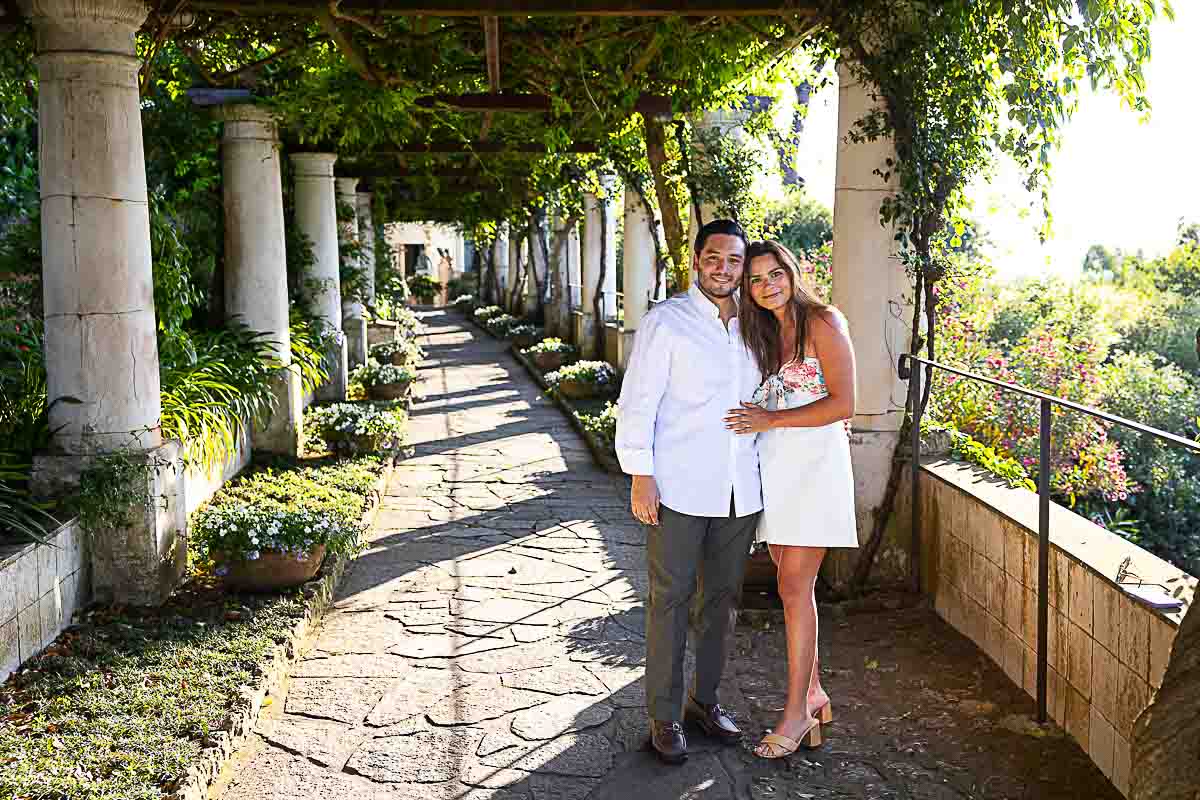 Couple posed for an engagement photo snapped under terrace balcony at sunset