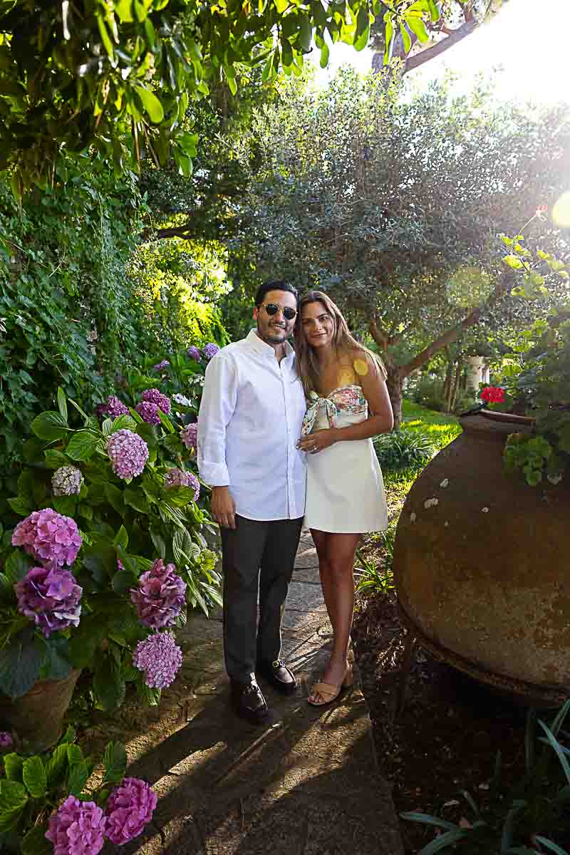 Portrait photography lifestyle photo shoot of a just engaged couple taken in a garden with flowers and vegetation