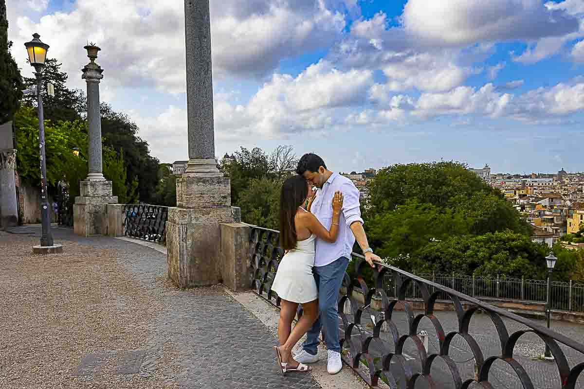 Out of the beaten track image while leaning metal fence Pincio terrace outlook as they take pictures with the expert photographer from Rome Villa Borghese Sunrise Proposal