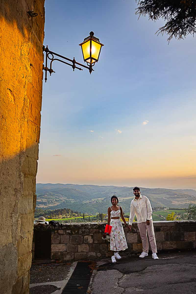 Couple posing together for some portrait pictures during a Tuscan sunset