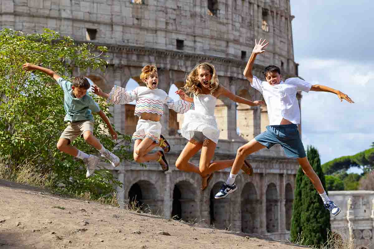 Picture frozen in the air while jumping up fun family picture at the Colosseum. Rome, Italy. Image taken during a walk photoshoot