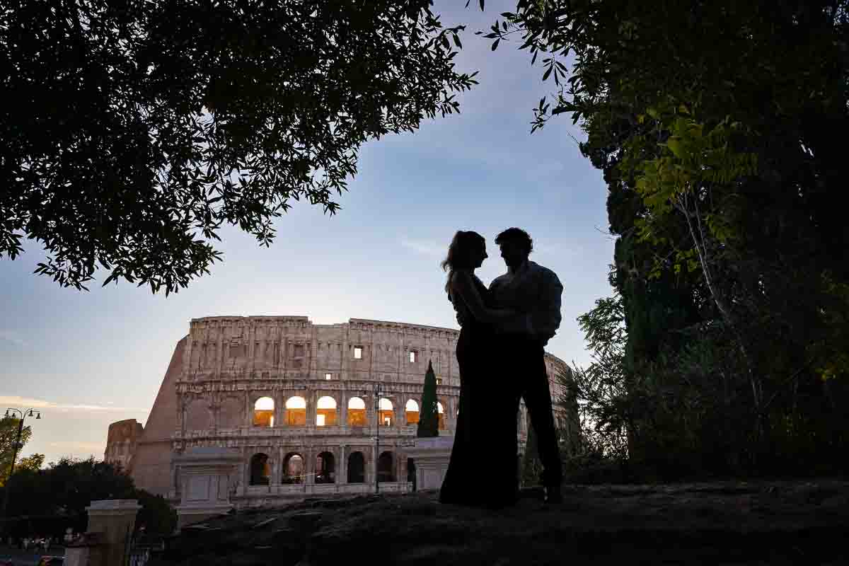 Silhouette picture of a couple posing before the camera Coliseum during a photographer session