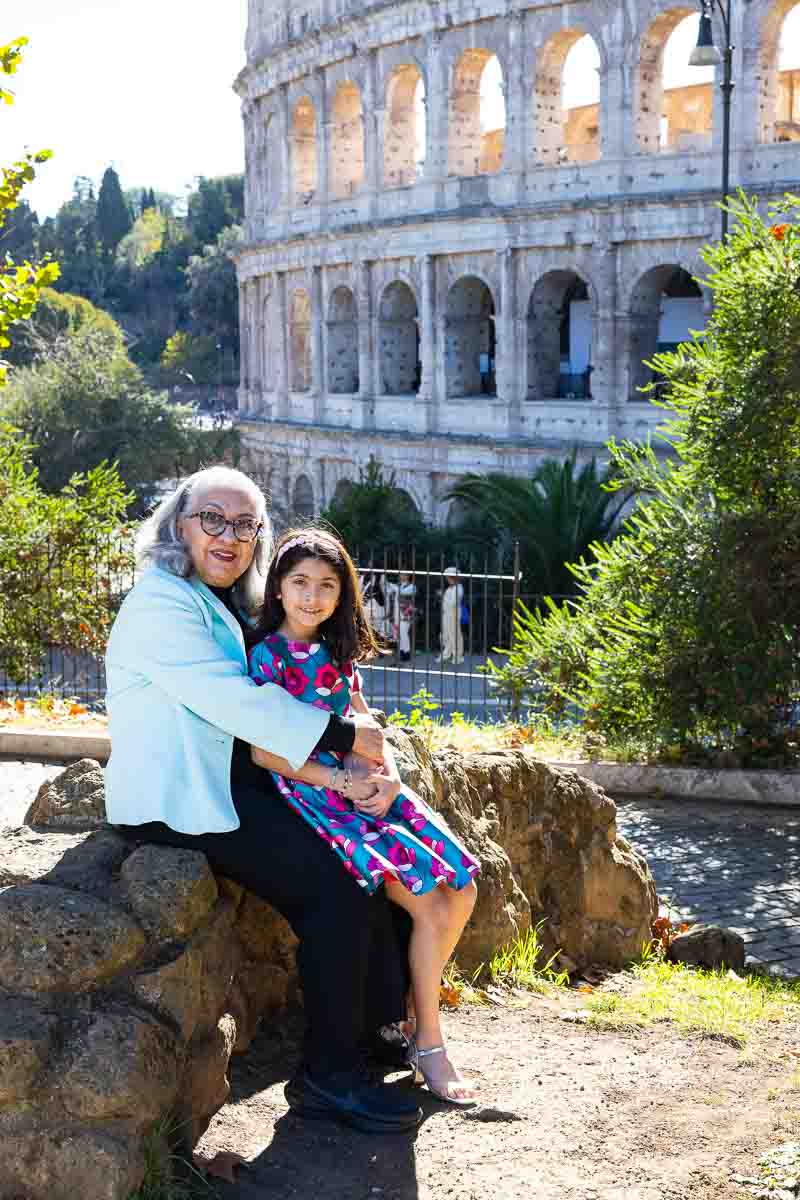 Sitting down grandma and granddaughter photographed while together in front iconic monument