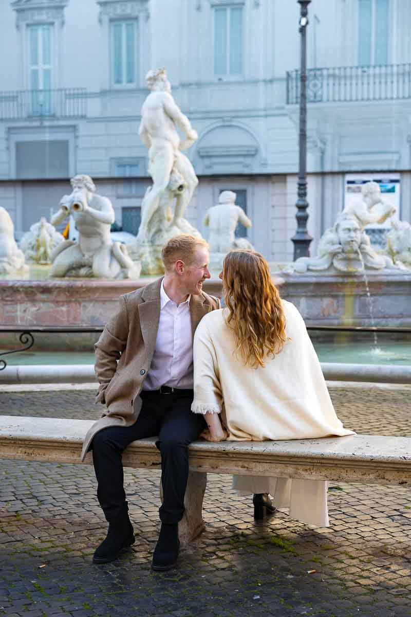 Sit down snapshot together in roman square navona taking cinematic style pictures