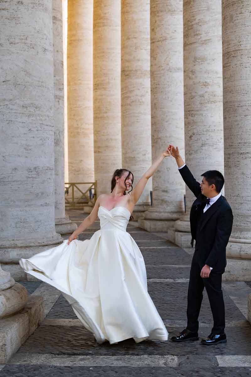Newlywed after blessing photography: romantic spin pose under the historic Bernini columns.