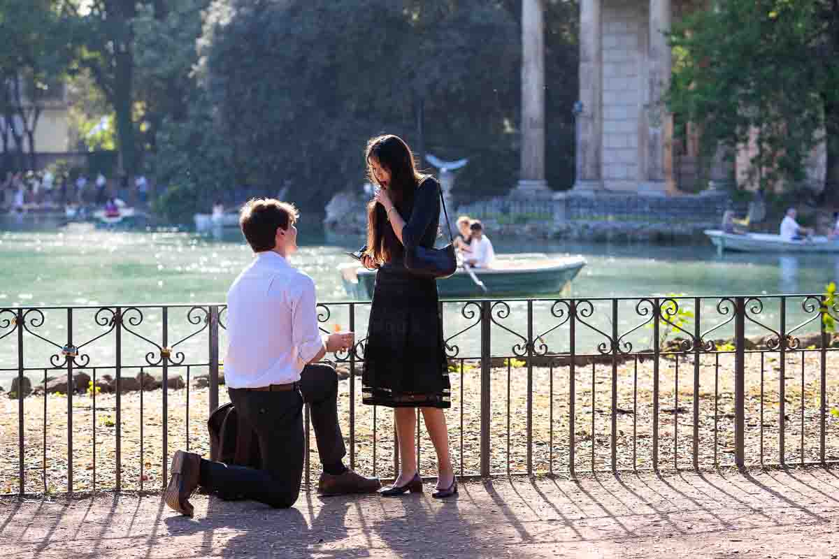 The proposing moment photographed candidly at the lake in Borghese lake park by a hidden photographer shooting from afar to maintain the element of surprise