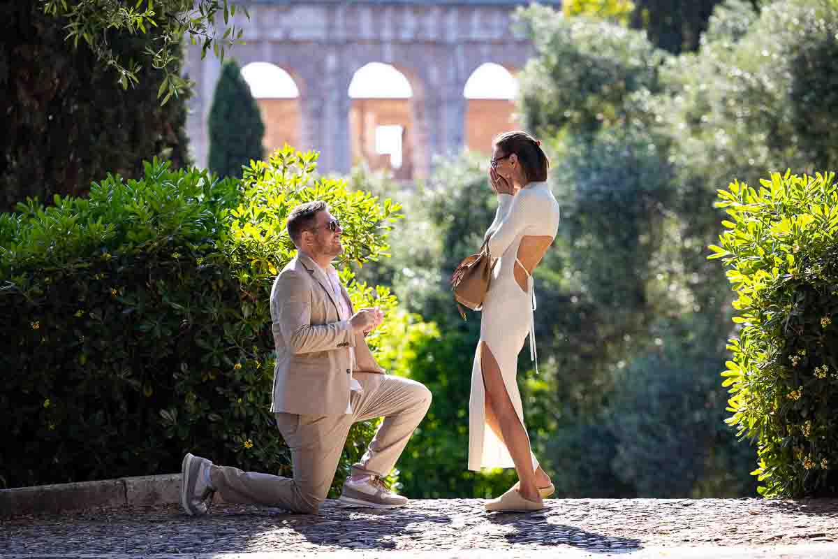 Coliseum wedding proposal with a knee down photo of the key moment 