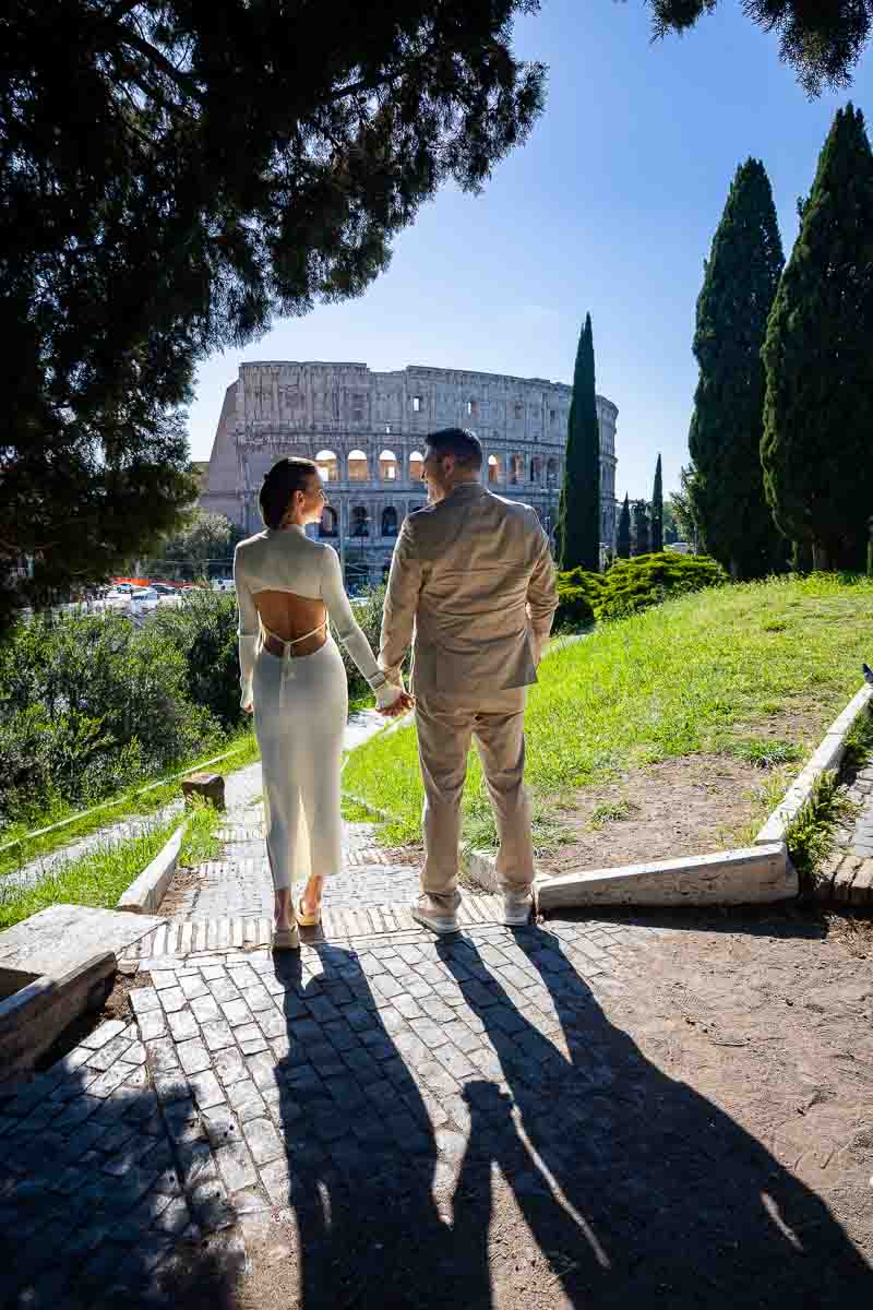 Holding hands and looking at each other while taking pictures during a photography session 