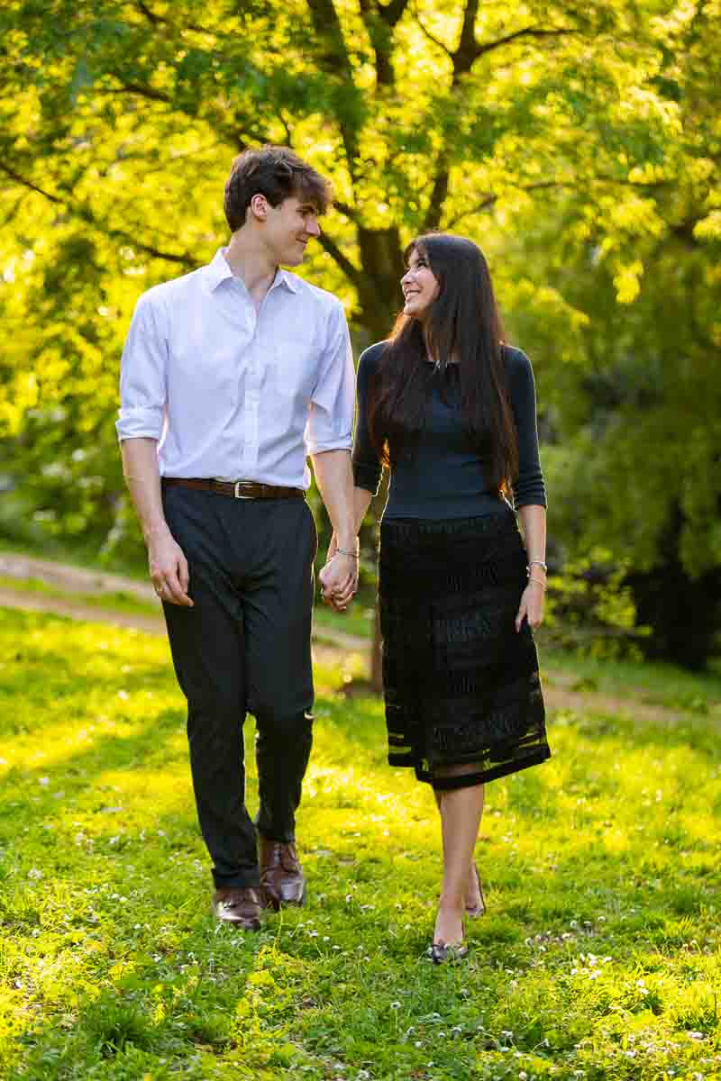 Walking together in a park within the greenery while ona photoshoot with professional photographers