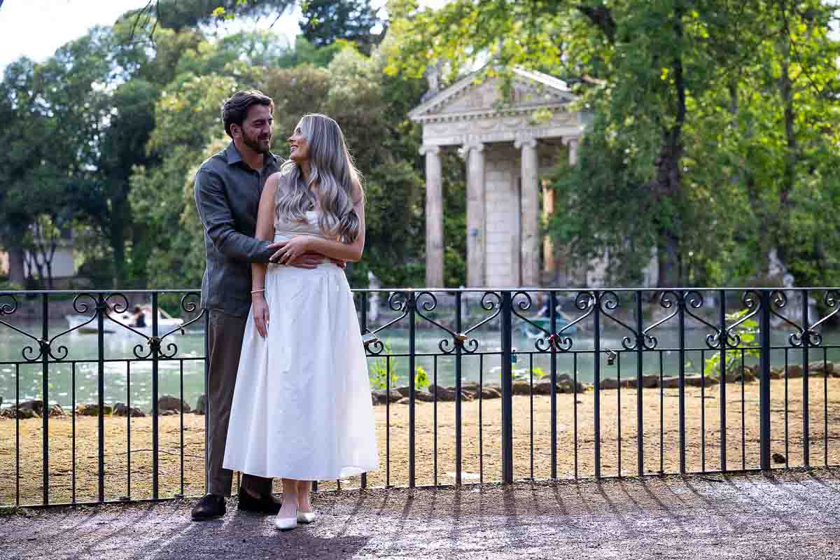 Posed photograph newly engaged taking portrait pictures by the lake in Rome