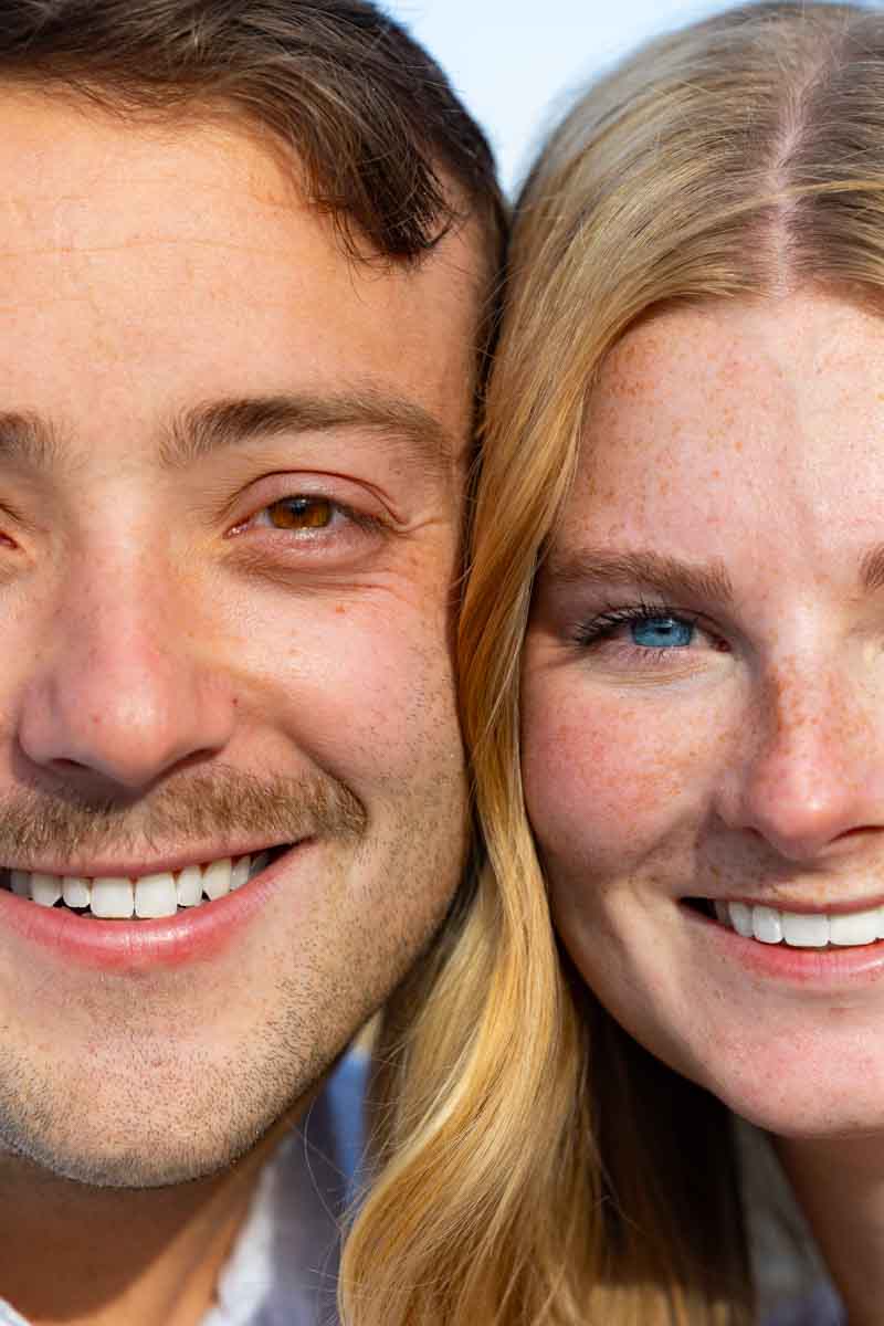 Close up portrait picture of a couple smiling and facing the camera for professional portraiture photography
