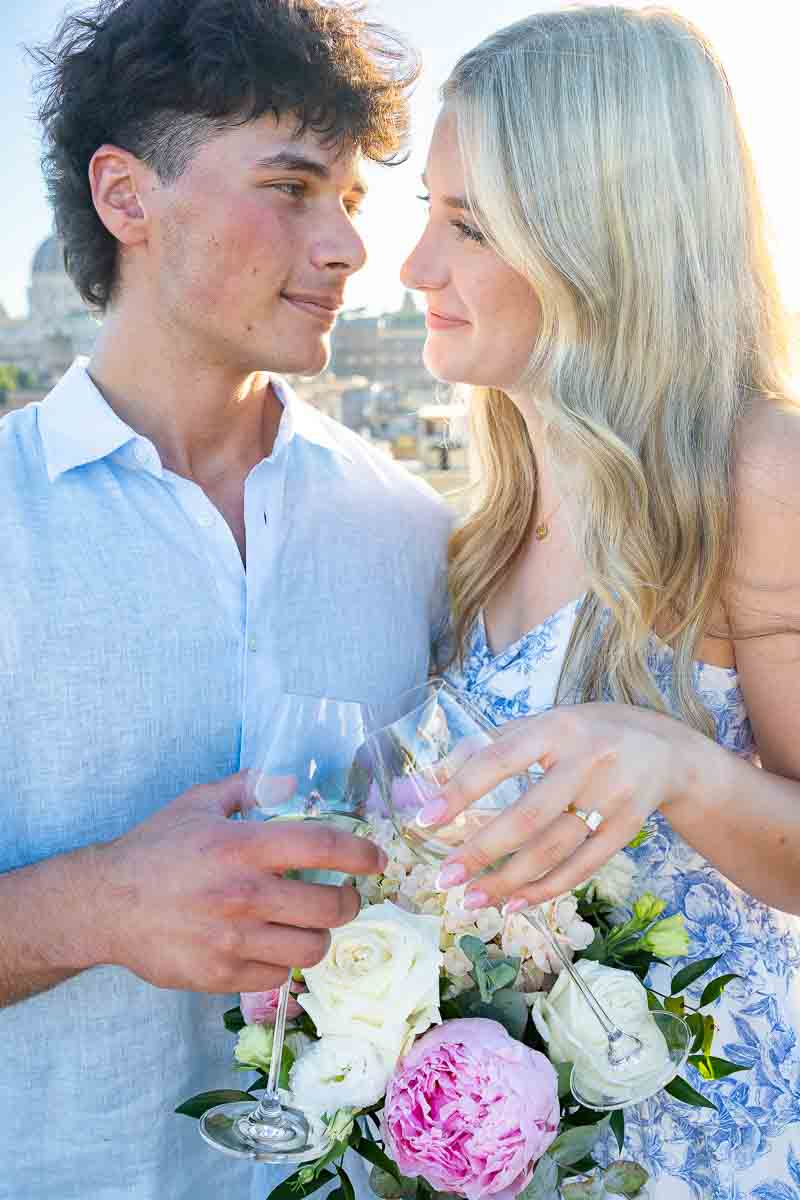 Engagement photo taken with prosecco wine glasses flowers building the image in a wonderful couple engagement portrait