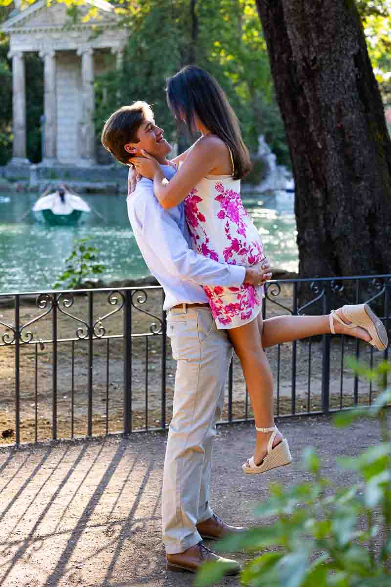 Pick me up pose photographed at a distance by a professional photographer expert in capturing proposing moments