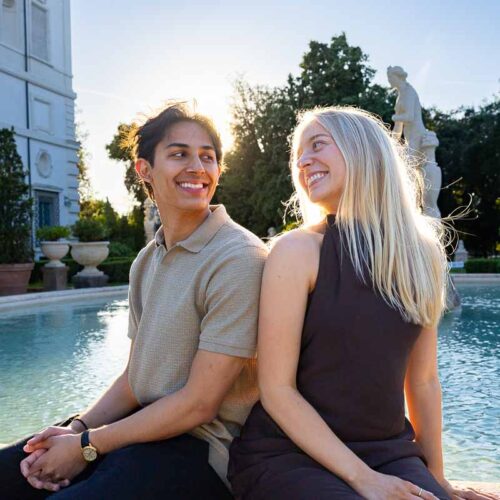 Sitting next to one another and looking at each other during golden hour dusk