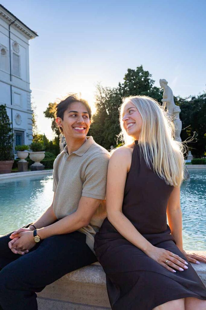 Sitting next to one another and looking at each other during golden hour dusk